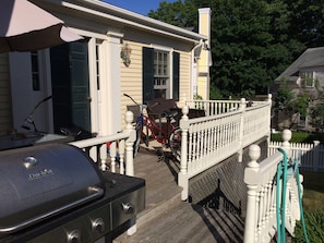 Secluded outside deck overlooks back yard and has seating for 9