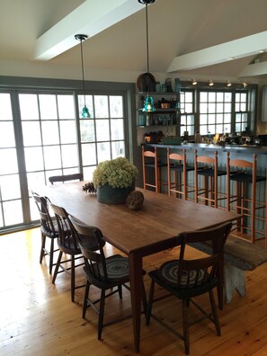 Harvest table overlooking the Mad River seats 8-12.  Hot tub is on the back porch