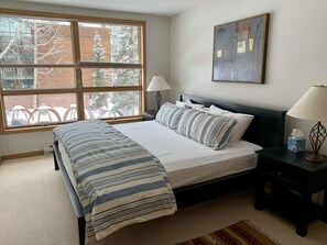 master bedroom, king bed, full window blinds open from top or bottom 