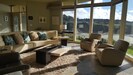 Floor to ceiling windows give unblocked view of beach and ocean below