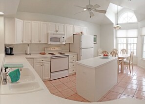 Open Kitchen in front of house with island and open area to living/dining room