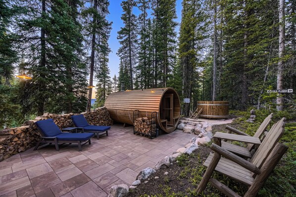 Relaxation patio w/ barrel sauna, chaise chairs and cold plunge.  