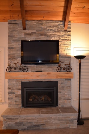 Great room has dry stack stone gas fireplace with 42' plasma TV.