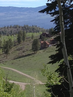 Looking at the cabin from the Elk Meadows water tank. (House with white car.)