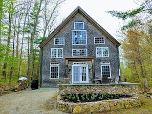 Front of the house with the granite and flagstone patio facing the lake.