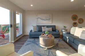 Living room off of the kitchen and dining room with patio access