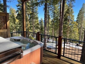 Take in the fresh air and incredible lake and forest views as you soak in the hot tub on the outdoor patio