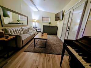 Private living room w/ full-size fold down sofa & Queen-size Murphy bed chest
