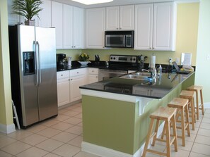 Gorgeous fully equipped kitchen with snack bar and adjacent wet bar.