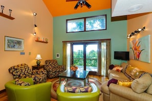 Ground floor living room has plenty of seating and views of mountain sunset.