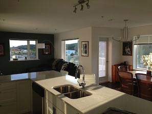 bright sunny living room, dining room and view from kitchen counter