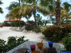 Breakfast on the terrace outside living room.  View of pool and the sea.