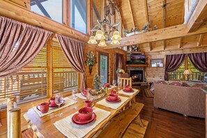 Log dining table and bar with extra seating. Reserve today! Vacations by Fayla.