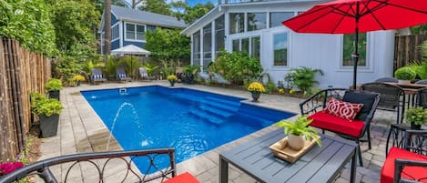 This private oasis includes a 12x27 in-ground pool, complemented by stunning hardscaped areas that enhance its beauty.
