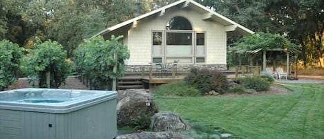 Acorn Cottage features a private hot tub, deck, and patio with BBQ.