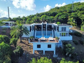 Drone shot of the house as it faces the ocean.

