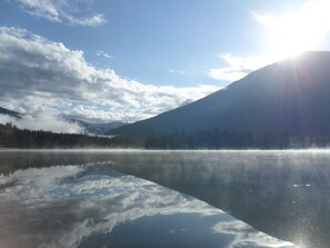 Savage Lake  from the lawn,  the sun just coming up burning off the fog.