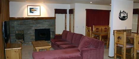 Living room with 60 inch flat screen TV & queen sofa bed, Dining room