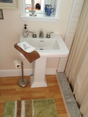 Rosalie bath with custom river rock shower is on the main bedroom level.