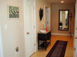 Hallway separates guest area and leads to kitchen.