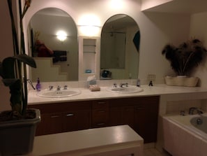 Double vanities and plenty of cabinets to store personal items.