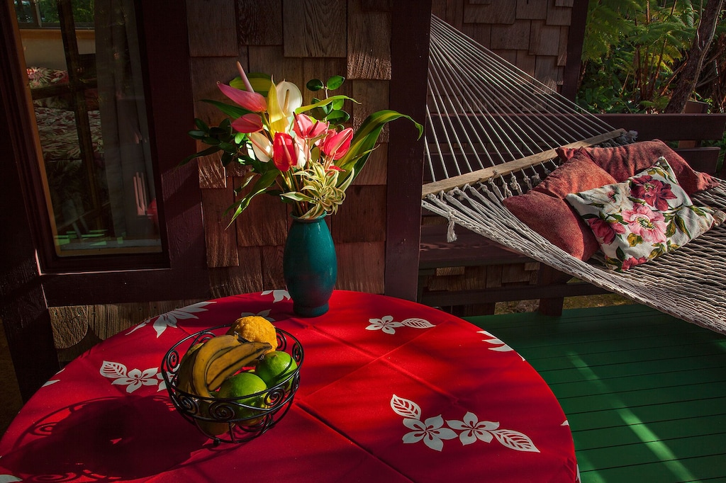 Red table cloth and hammock at the lanai of this unique Airbnb Hawaii Big Island