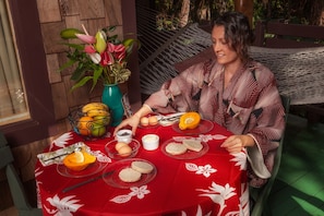 Breakfast on the porch/lanai. with Guest dresses in a "hapi" happy coat.