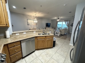 Kitchen is stocked with dishes, pots, pans, cooking utensils, etc. 