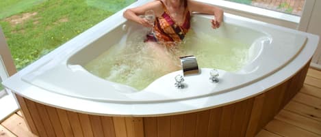 Large two person Jacuzzi in sunroom. 