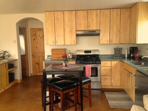 View of kitchen area looking towards bathroom on left and bedroom on right.