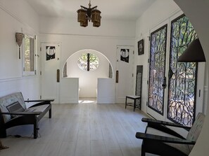 looking from bedroom into the Mackintosh room with wrought iron french doors