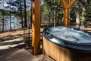 Private hot tub on deck with forest and lake views