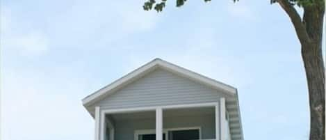 A view of the house from the beach, with walk-out porch and private balcony. 