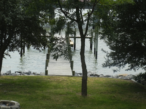 View of the water and pier from 2nd floor deck on house.