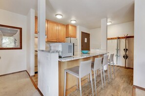 Fully stocked kitchen with bar stools for additional seating.  