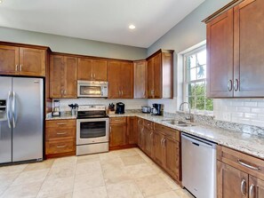 Large kitchen with granite counter tops and stainless appliances