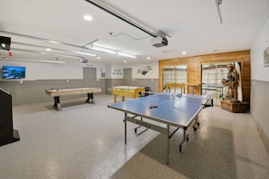 Detached game room features ping pong, air hockey, darts, foosball, and more