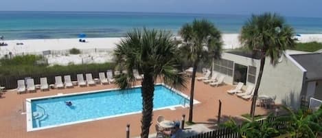 View of pool and beach from the upstairs balcony all within steps of each other!