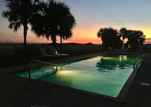 Sunset view from the pool area. Safety Lighting in pool & accent lights on palms