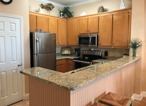 Fully equipped kitchen with dining bar & separate storage pantry closet.   