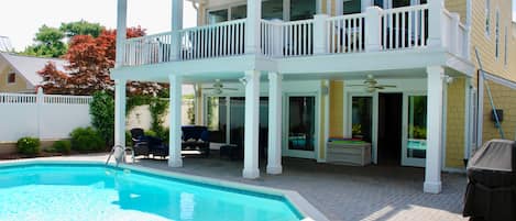 Shaded patio and gas grill.