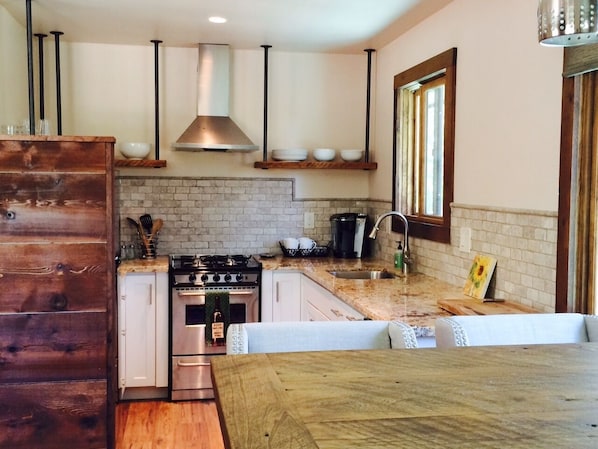 Reclaimed barn wood dining table and kitchen shelves.