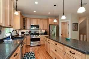 Prepare meals in the roomy,  well-equipped kitchen with island.