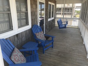 Cozy screened-in porch with all-weather chairs and swing!