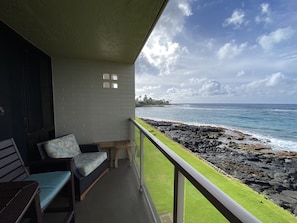 Southeast-facing view where the sun rises. Comfy club chair with side tables.