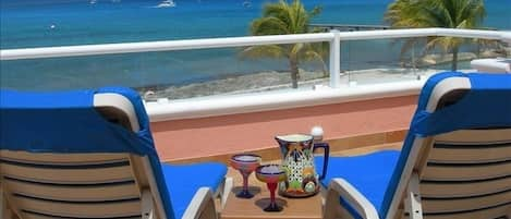 Relaxing with margaritas on the terrace, watching the dive boats drift by.