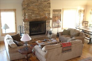Warm up by a wood burning fire in a sun lit living room.