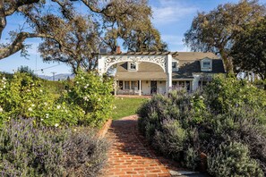 Beautiful gardens and roses arch entry.