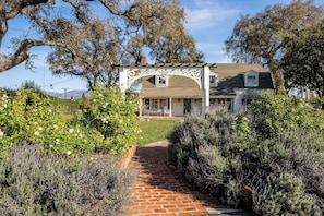 Beautiful gardens and roses arch entry.