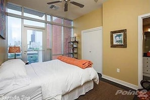 Guest bedroom is spacious with a flat screen tv.